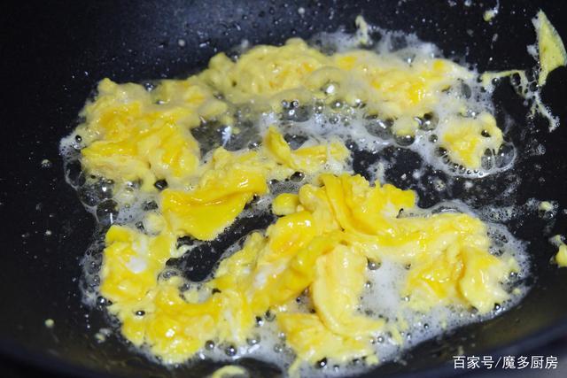 3,炒锅上火烧热,放食用油,把蛋黄液倒进锅里,炒成鸡蛋块后盛出放在